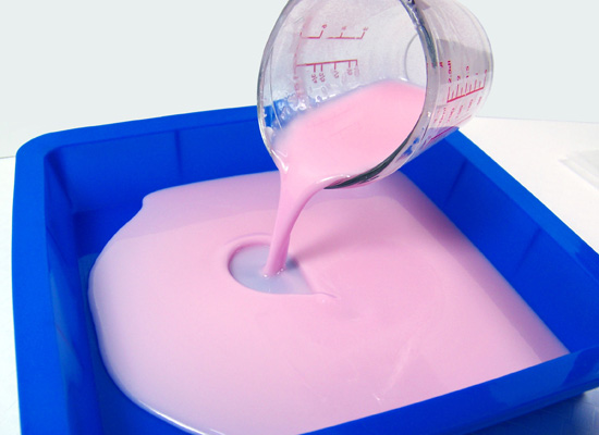 pouring the pink portion of the soap