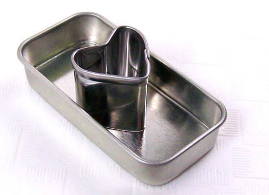 place heart cookie cutter into center of each tin