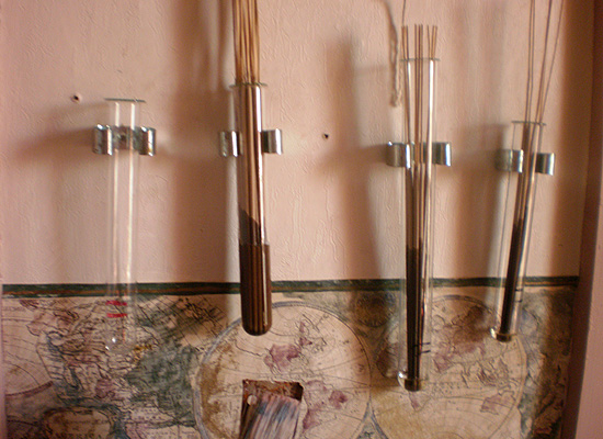 broom holders mounted to wall to hold incense sticks