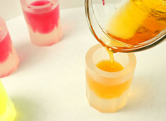 pour orange base into each glass, leaving that same 1/2 inch space at the top