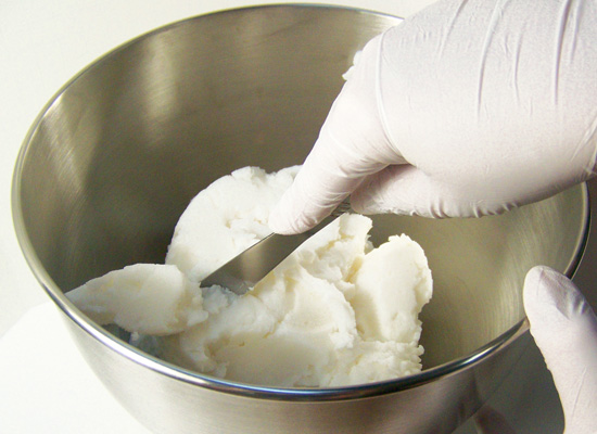 cut up foaming bath butter base with a butter knife