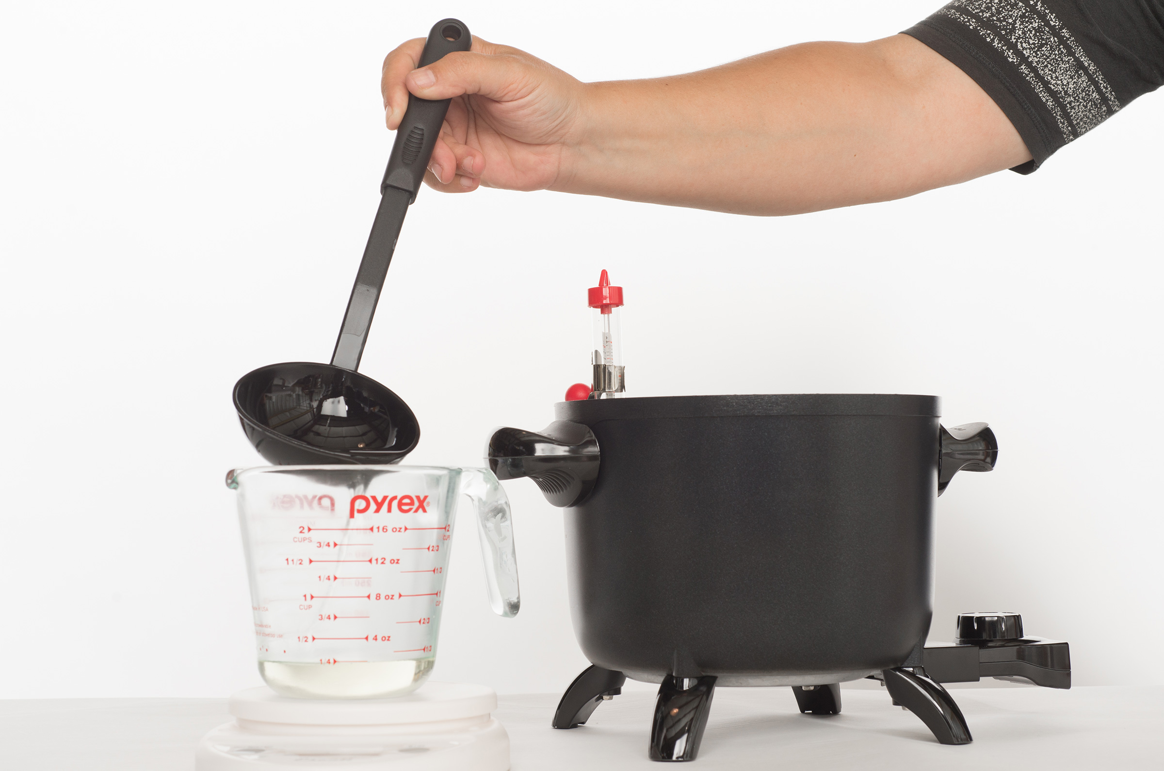add melted wax to pouring pot or pitcher